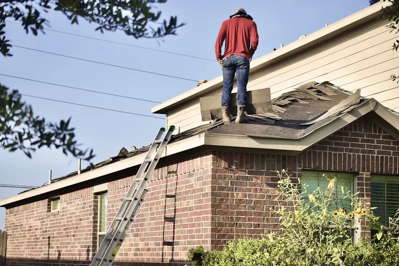 Professional roofer working on a residential roof in Calhan